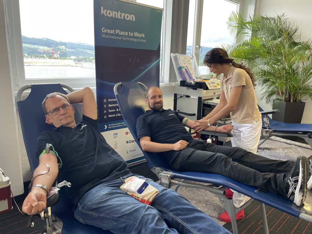 Two men donating blood.